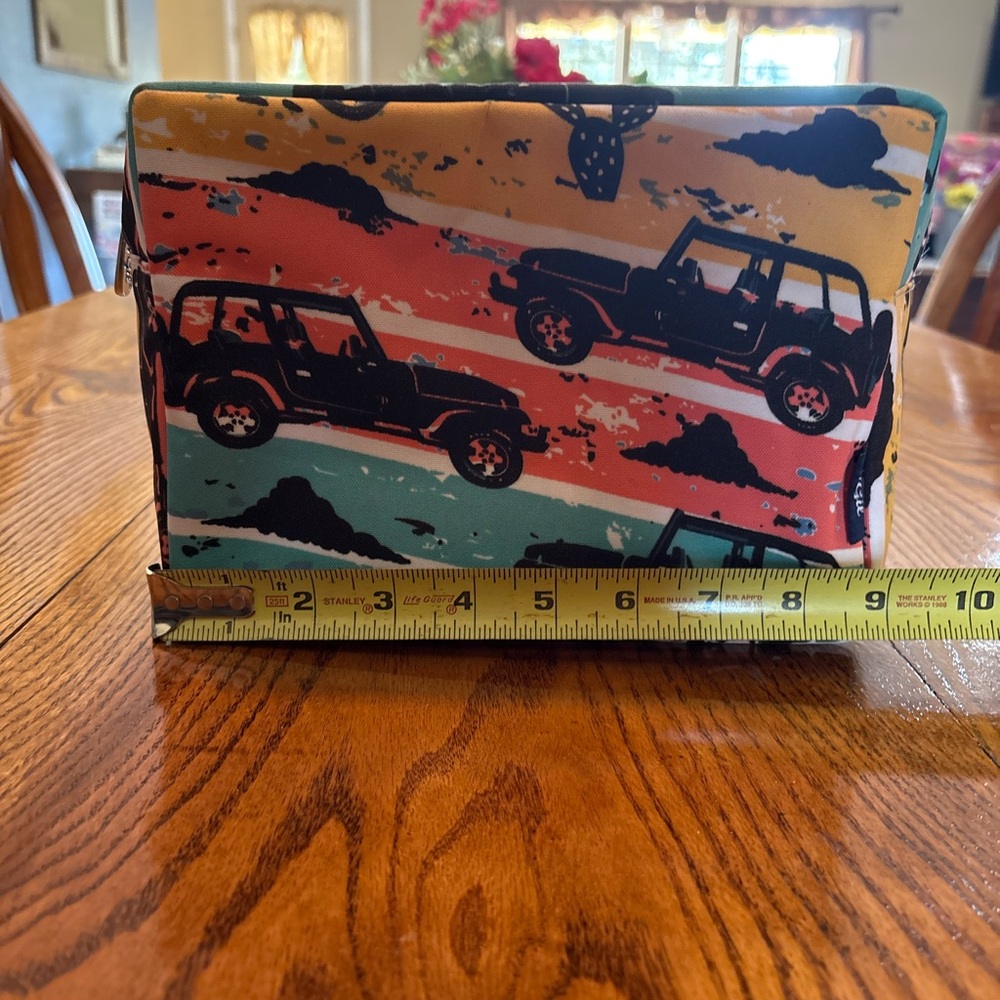 Jeep print make up bag, approx. 9” (width) x 6 ½” (height) x 3 1/2” (depth)